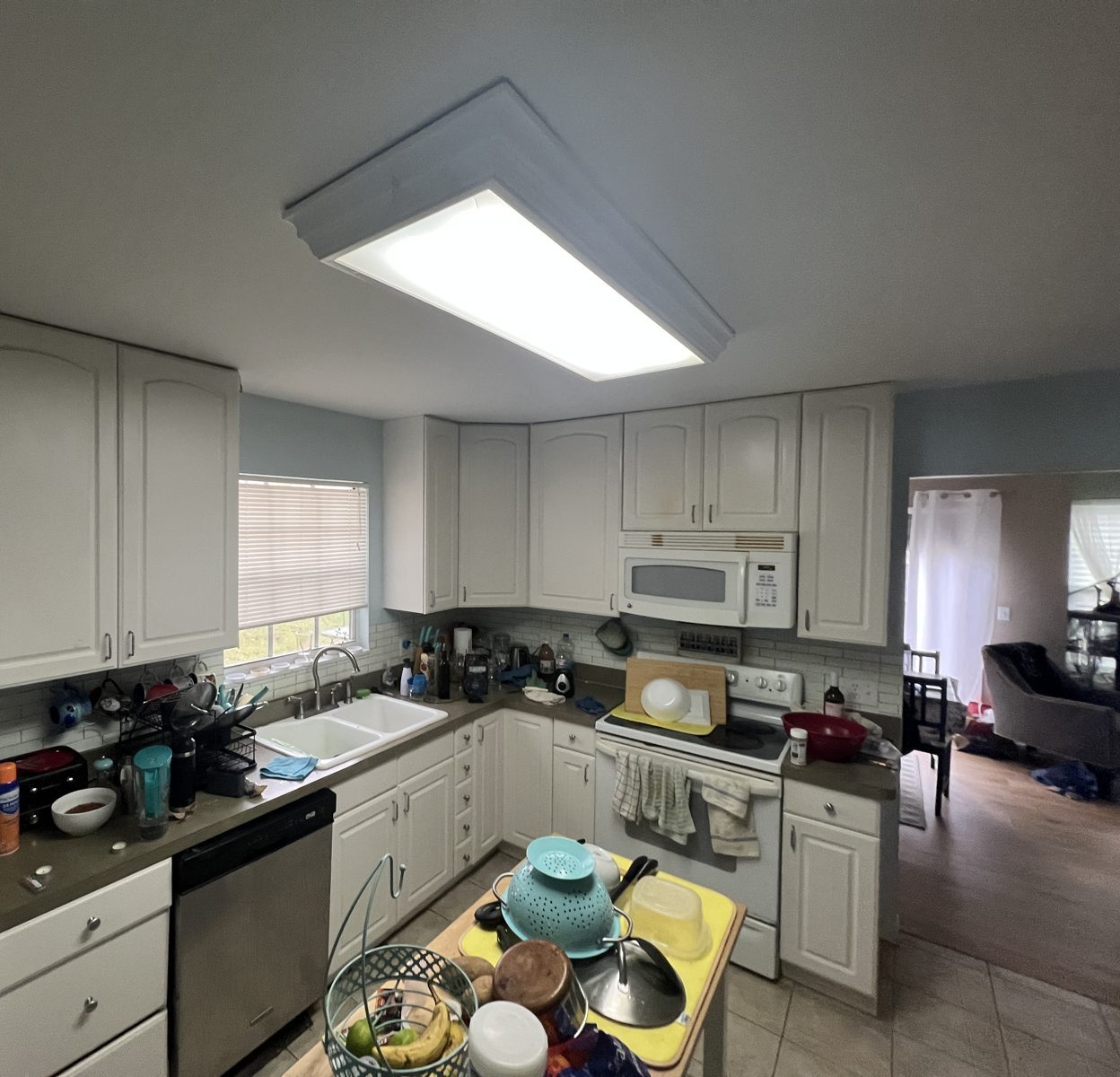 Before: original kitchen with dated cabinets and laminate counters