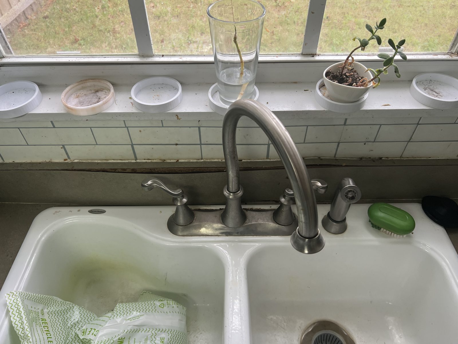 Before: stained double sink and worn countertop