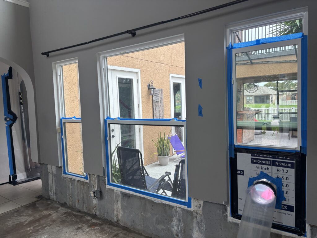 Air scrubber exhausting through a window to keep the area under negative pressure