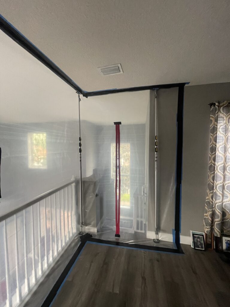 Containment wall with zippered entry at the stair landing